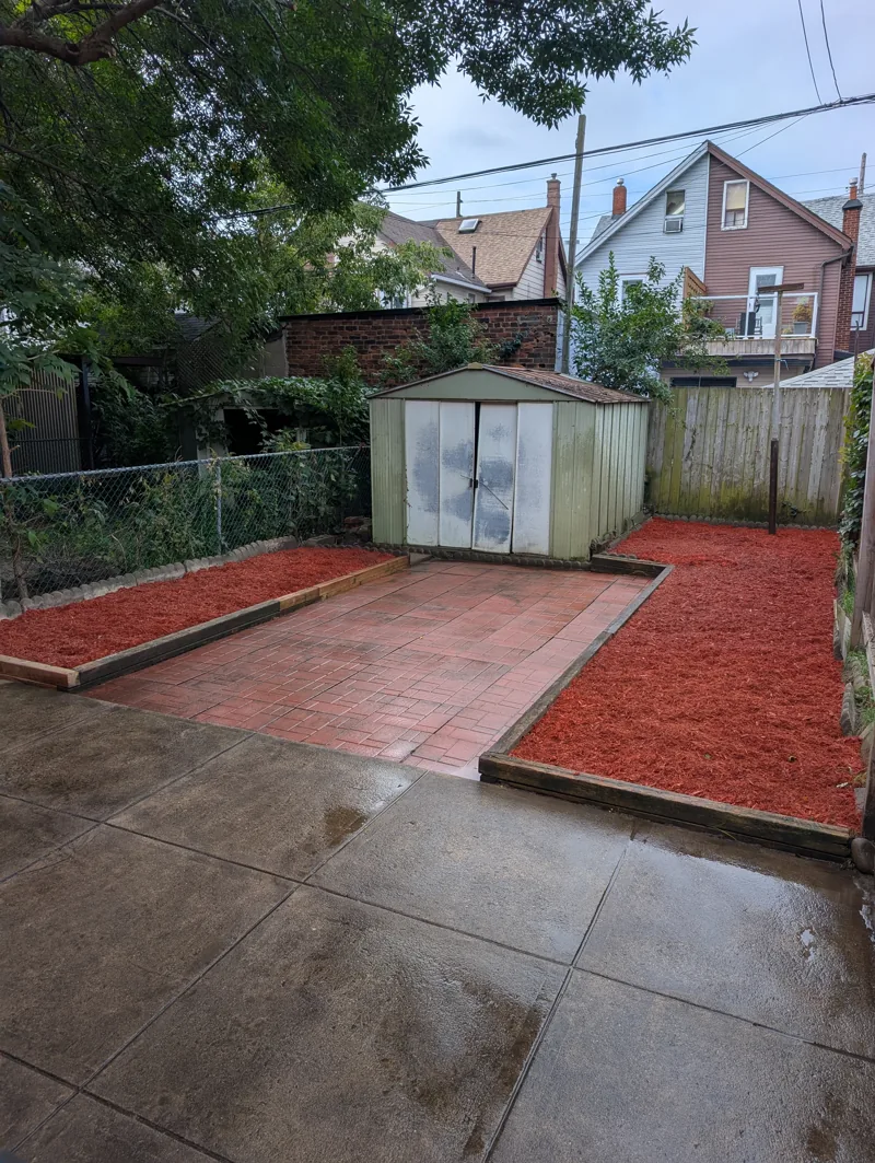 Finished backyard after cleanup and fresh mulch installation near Junction Triangle
