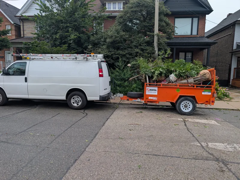 Trailer loaded with yard debris after a backyard cleanup near Junction Triangle
